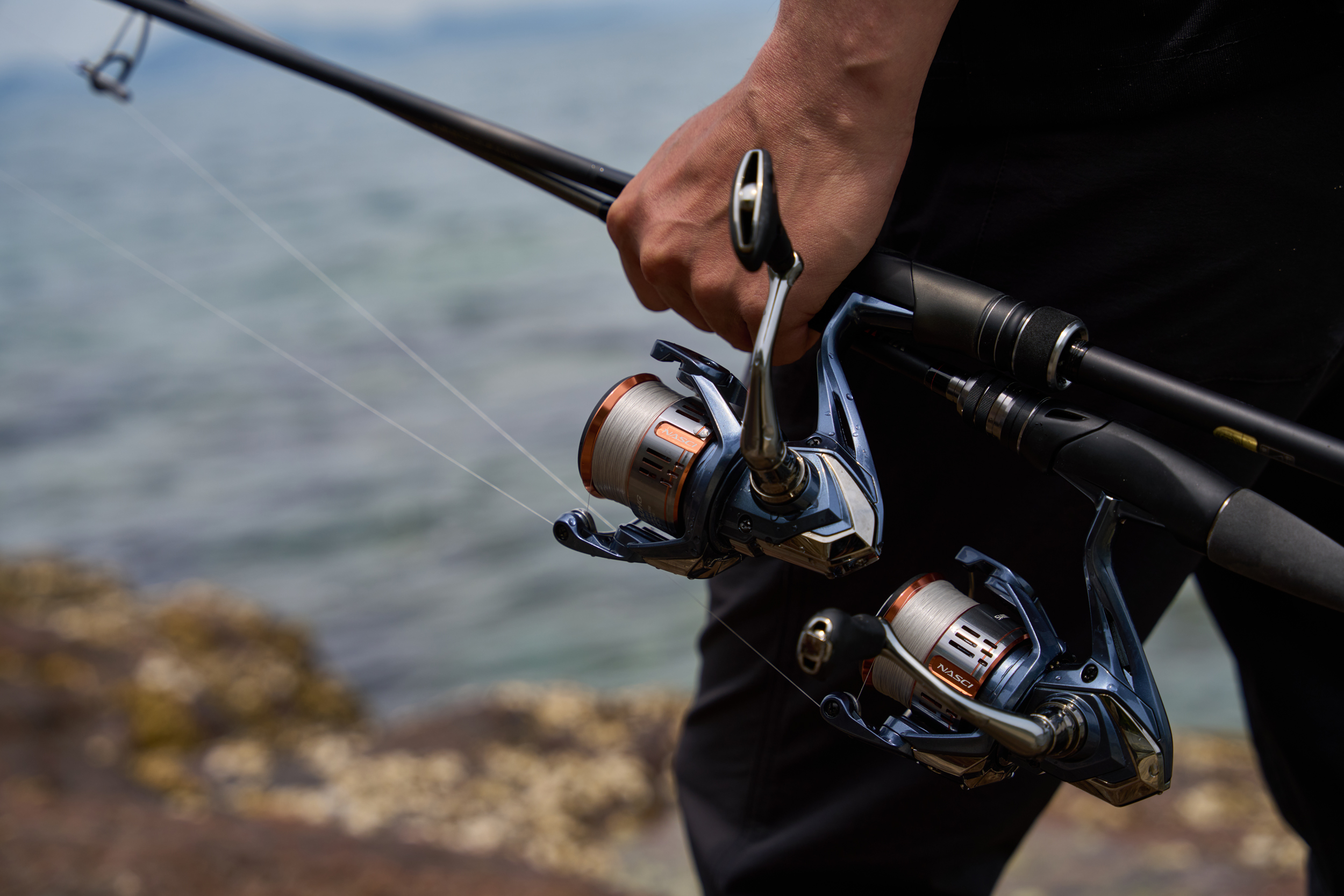 Angler holding Shimano Nasci reels